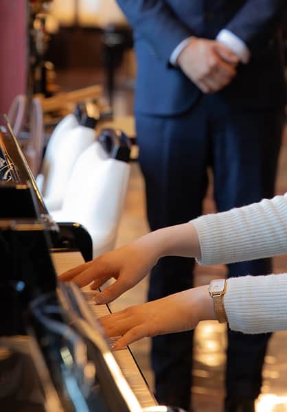 ピアノを弾いているスーツの手元の画像